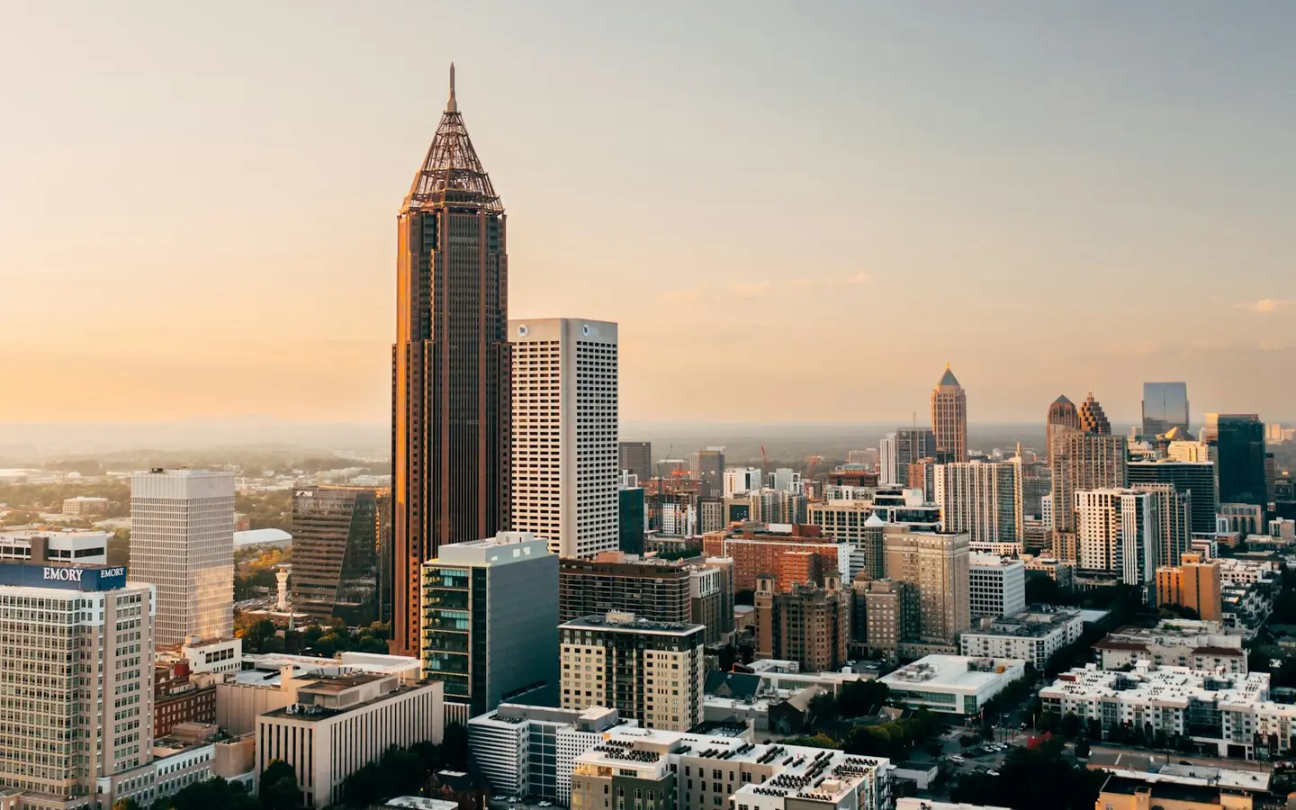 A city skyline of tall buildings under an open sky